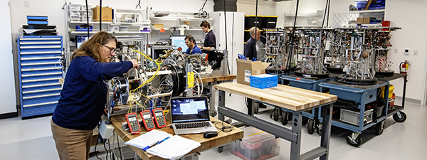 Engineers from MBARI’s SURF Center work in MBARI’s new robotic technology lab