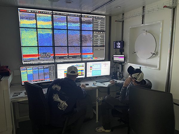 Research Technician Jacoby Baker (left) and Senior Research Technician/Backup CTD Technician Joe Warren reviewing acoustic data aboard R/V David Packard-600