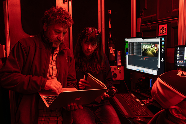 Senior Research Specialist Roberto Gwiazda (left) and Senior Research Technician Eve Lundsten (right) analyzing MiniROV dive data in the portable control room on the deck of IBRV Araon