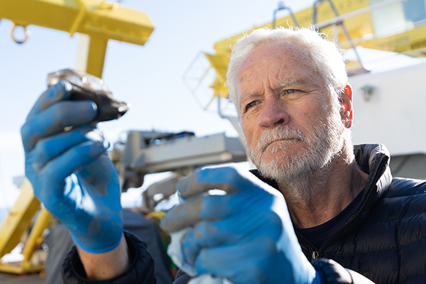 Senior Scientist Charlie Paull examining a piece of ice recovered from the seafloor in the Canadian Beaufort Sea-600